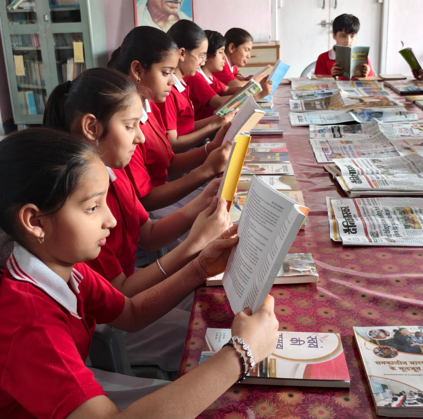 Students reading books in Pink Model School library